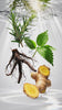 Rosemary, nettle, He Shou Wu root and ginger dropping into clear water
